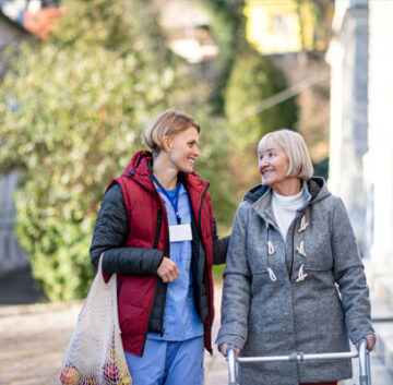 Assisted living advisor walking with senior in Long Island NY
