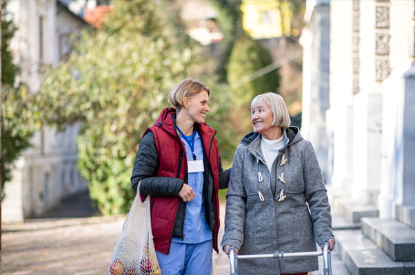 Assisted living advisor walking with senior in Long Island NY