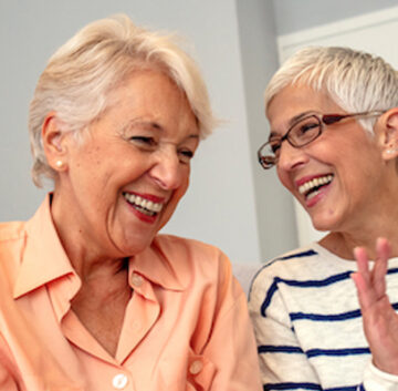 Image portraying a group of seniors engaging in social activities like conversation, games, and exercise, highlighting the importance of socialization for healthy aging.